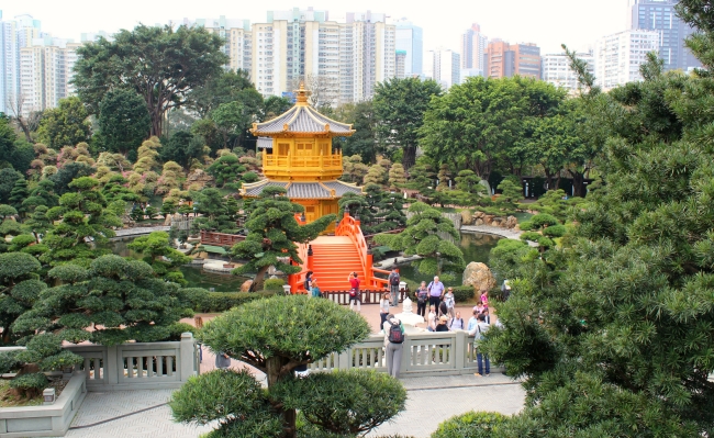 Classic garden with modern skyscapers in background